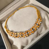 golden-beaded-floral-necklace-top-view-cotton-box-stylesense