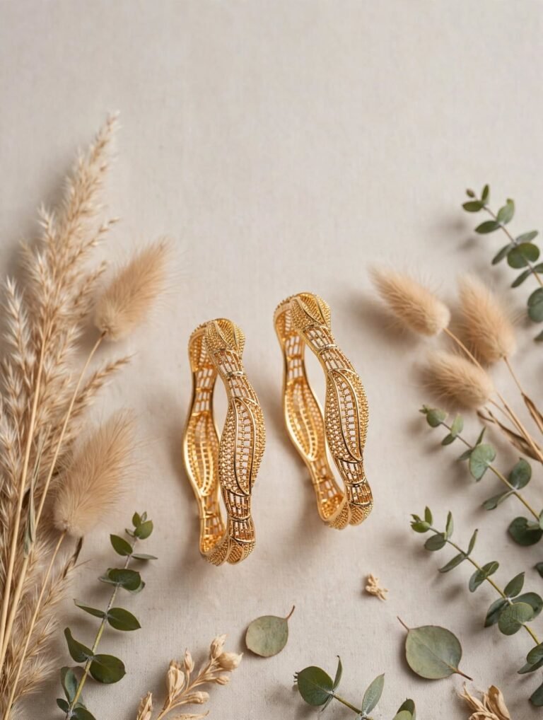 Wavy Gold Bangles in Pakistan: Complete Buying Guide 2025 Alt Text: Wavy leaf gold plated bangles pair flat lay with pampas grass - StyleSense Pakistan